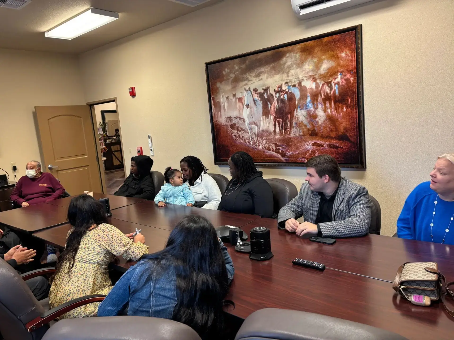 Group meeting around a conference table.